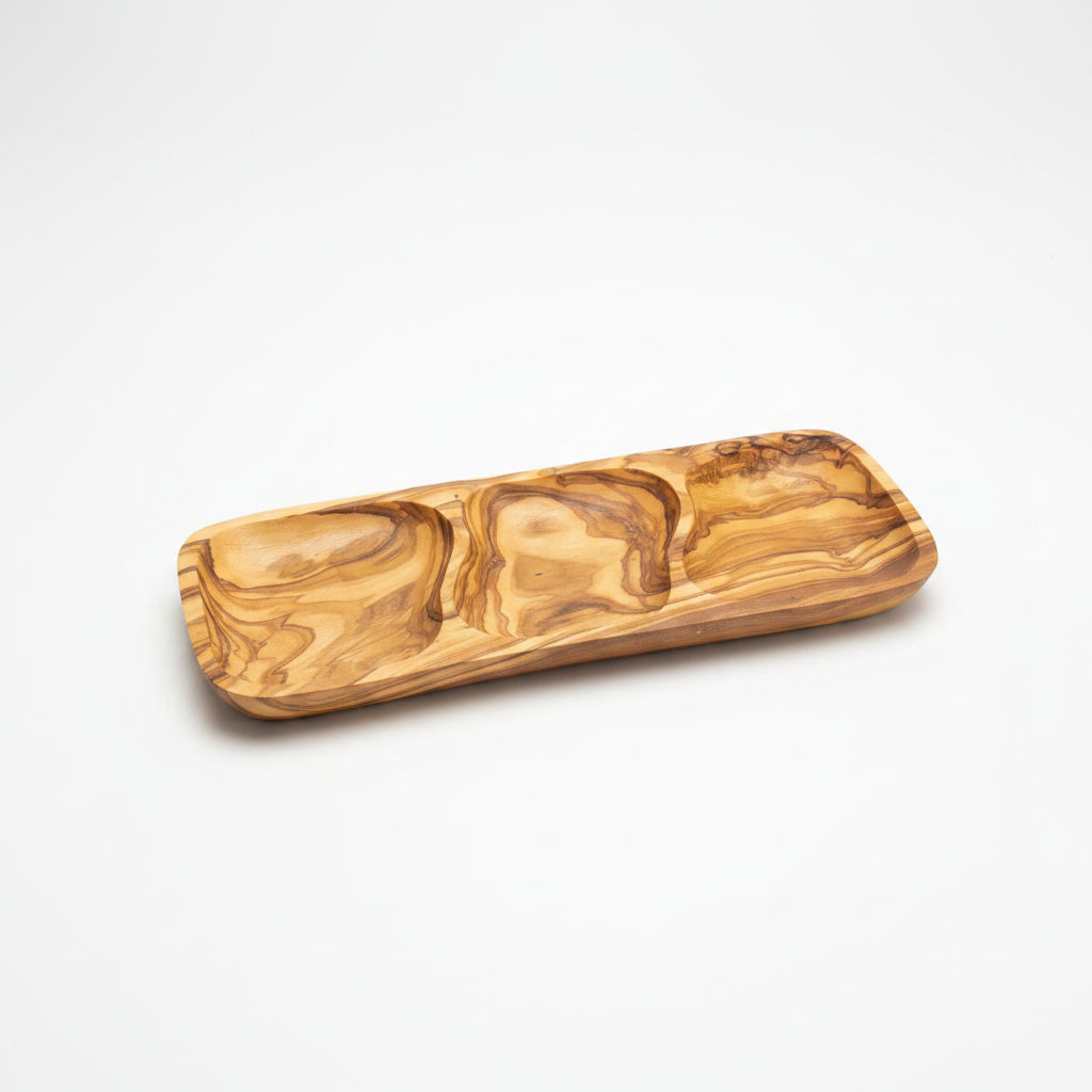A rectangular wooden serving tray with a wavy, marbled grain pattern, resting on a light brown wooden table.
