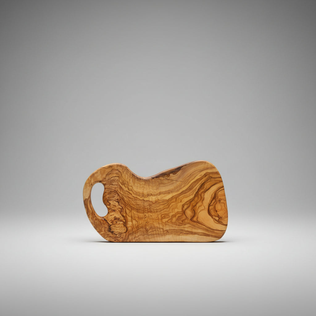 A rustic live-edge wooden cutting board with a natural handle, displayed on a light brown wooden floor.