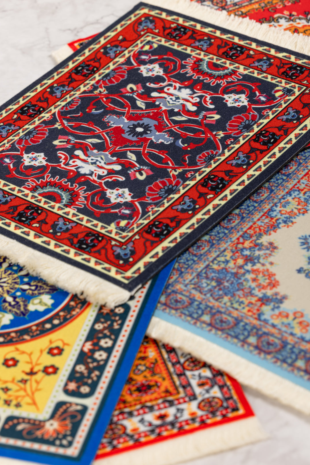 Collection of colorful patterned rugs on a light background