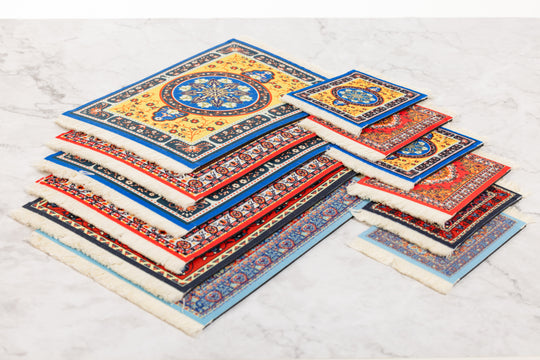 Set of colorful prayer mats stacked on a light gray surface