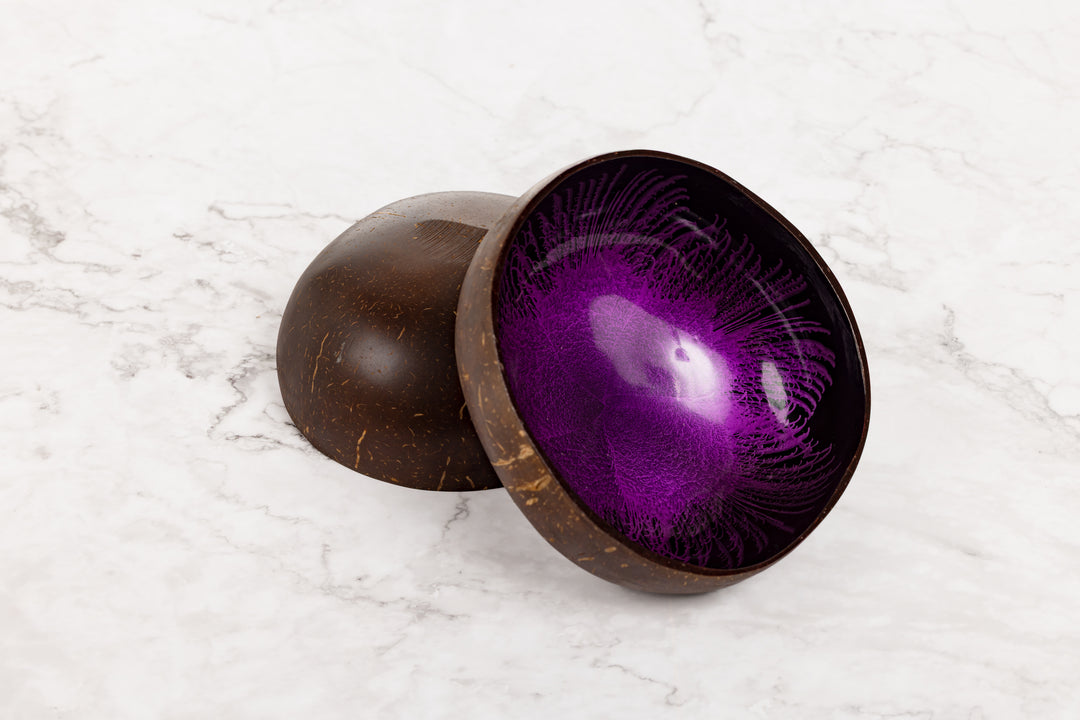 Purple interior of a wooden bowl on a white marble surface