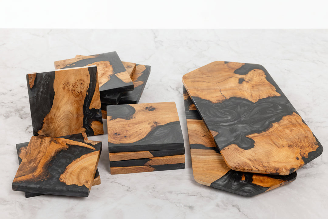 Set of wooden coasters with black accents on a marble surface