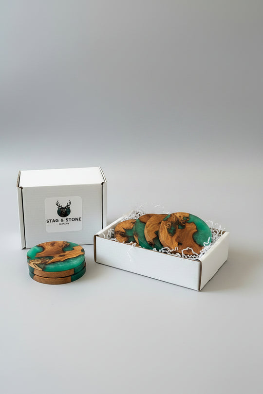 Wooden coasters with green and brown design in a box labeled &