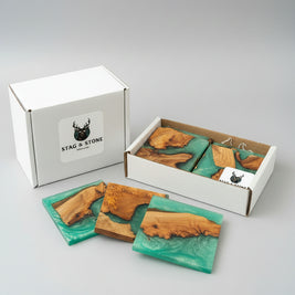 Wooden coasters with green resin on a wooden surface, branded 'Stag & Stone'.