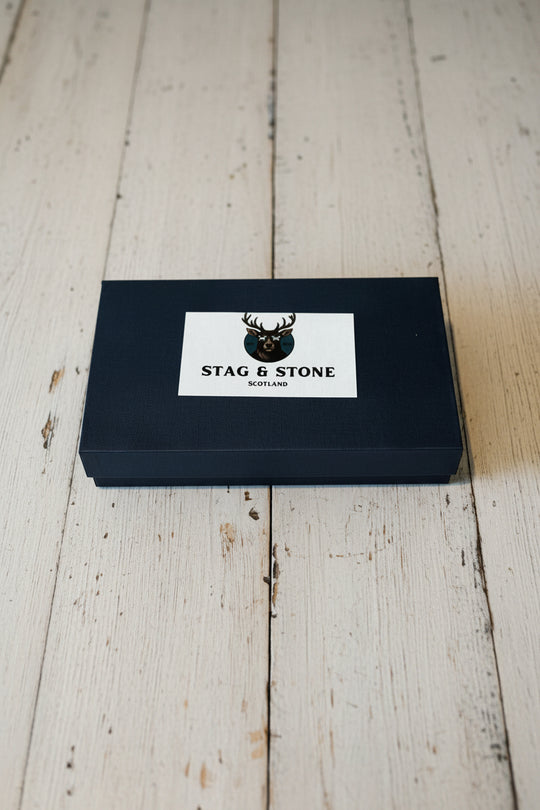 A black rectangular product box with a white label reading &