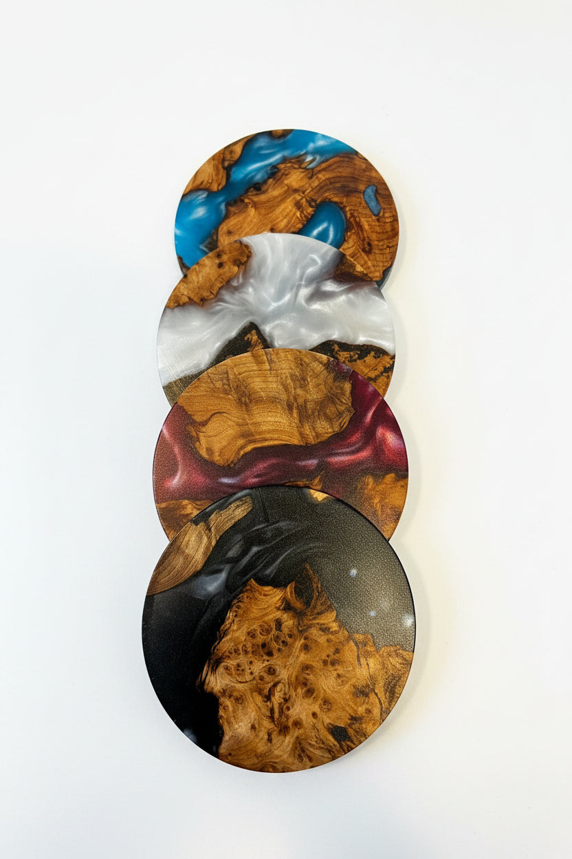Four overlapping oval coasters with a glossy burl wood grain pattern in various colors including blue, white, gold, burgundy, and black, displayed on a clean white background.
