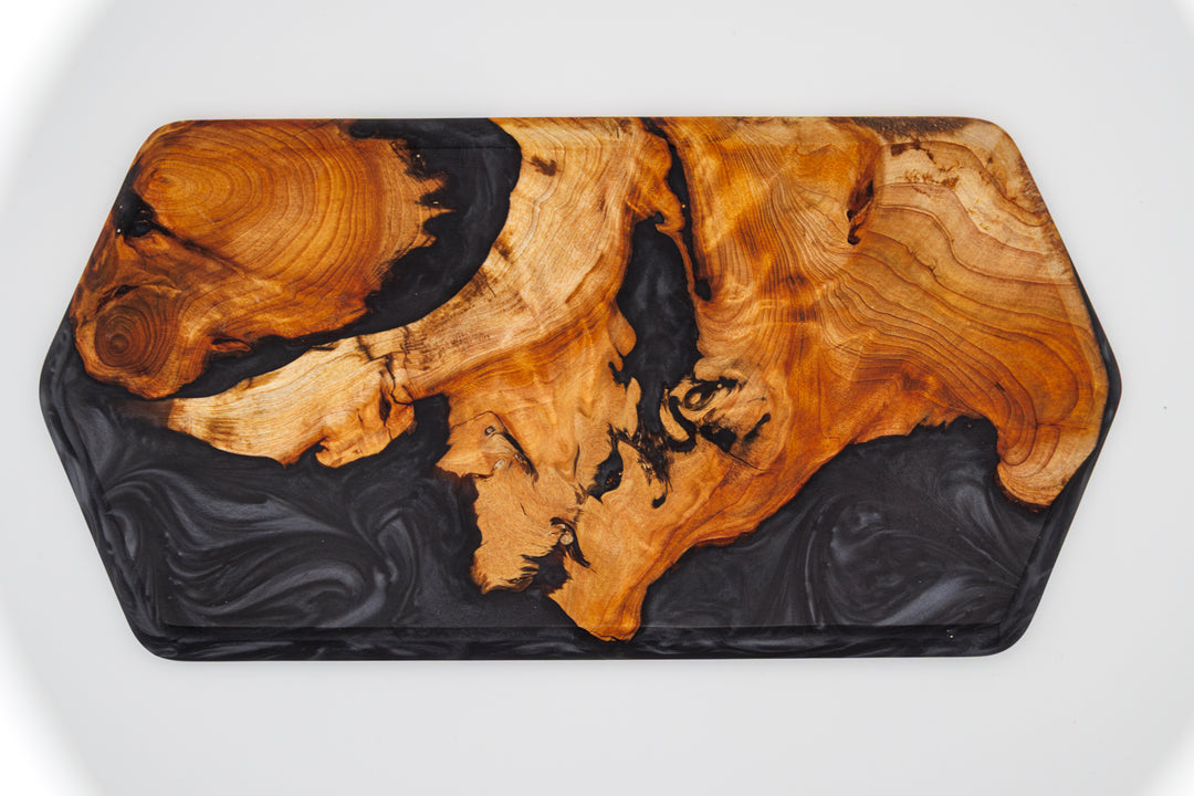 Wooden tray with black resin on a white background