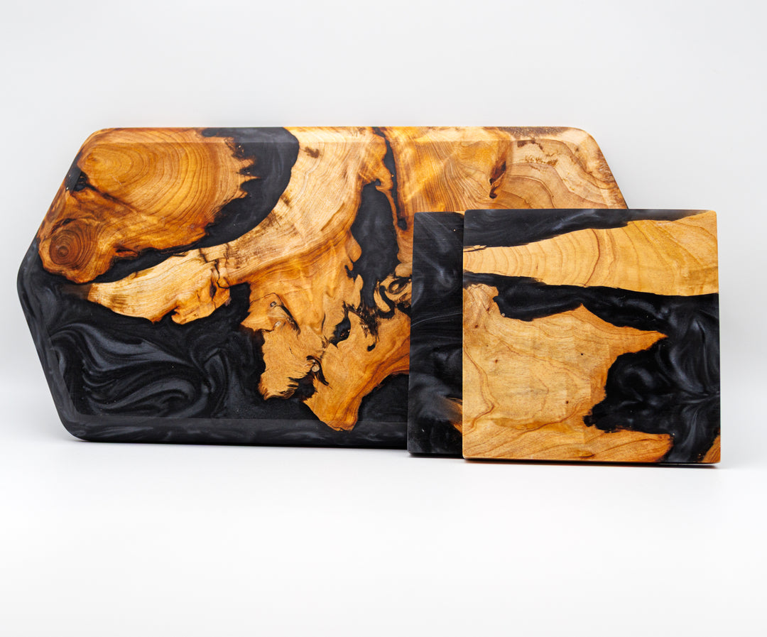 Two wooden trays with black and gold marbled patterns on a white background
