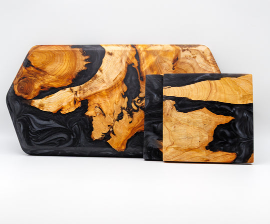Two wooden trays with black and gold marbled patterns on a white background