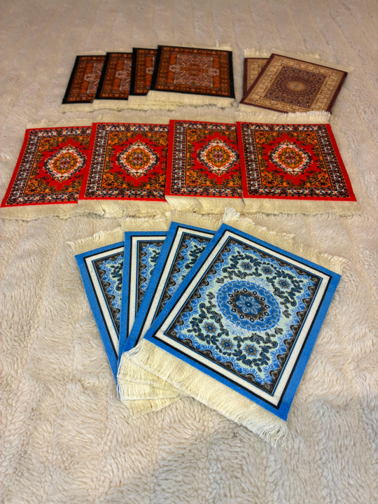 Collection of small decorative rugs and carpets on a beige surface