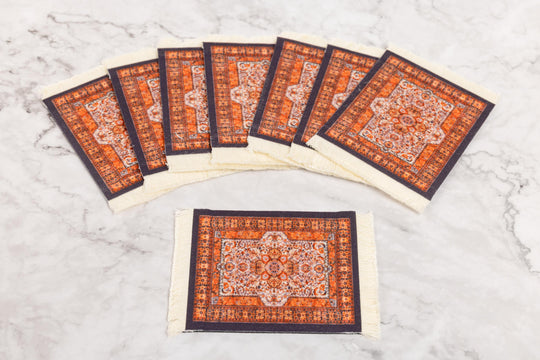 Set of six decorative coasters with intricate patterns on a light gray surface