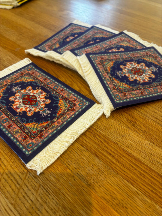 Three decorative coasters with intricate patterns on a wooden surface