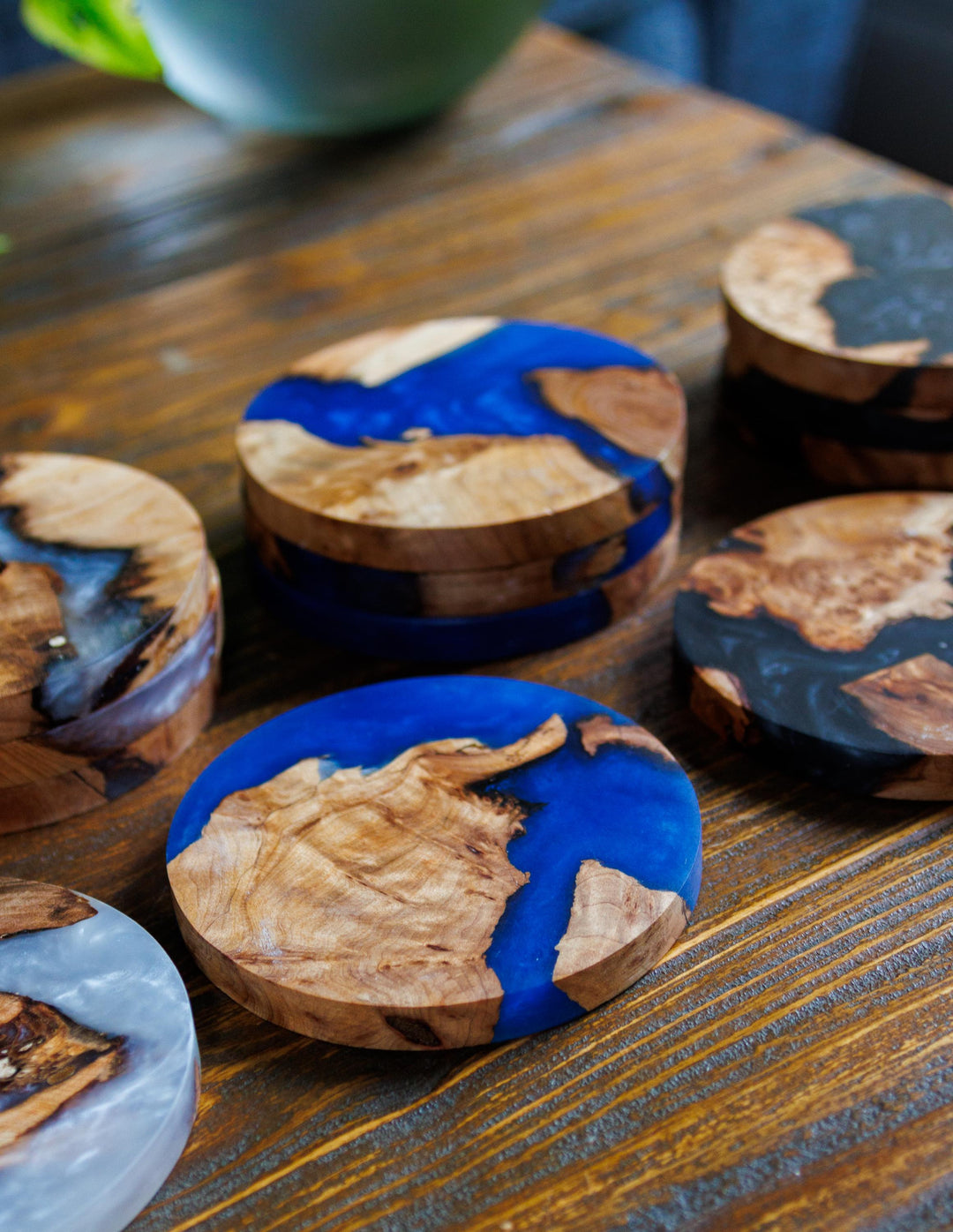 Wood and resin coaster sets on a table